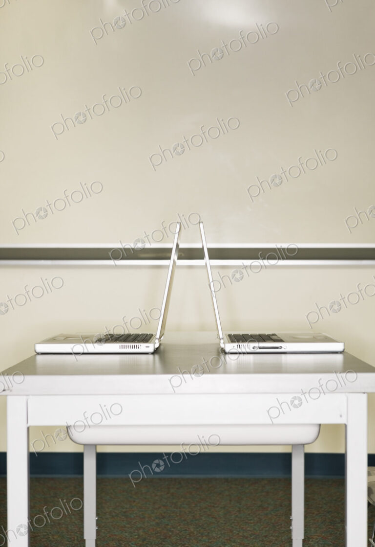 Two open laptops on a table.