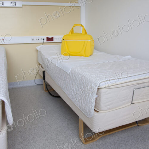 Two patient beds in a maternity unit, a bright yellow bag. Two patient beds in a maternity unit, a bright yellow bag.