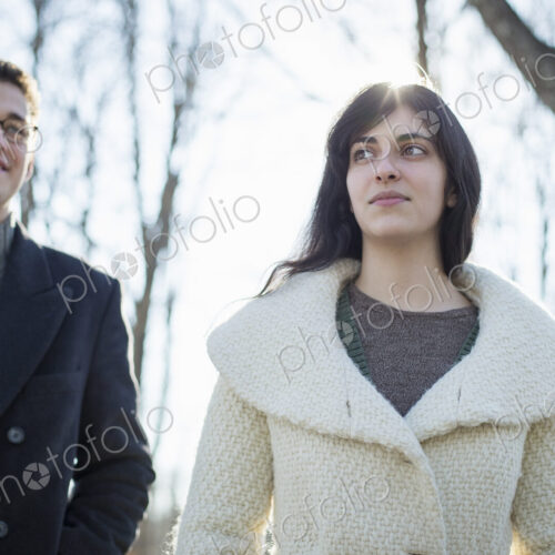 Two people, a couple, a man and woman in the woods on a winter day. Two people, a couple, a man and woman in the woods on a winter day.