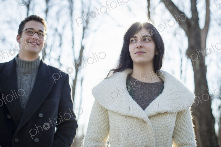 Two people, a couple, a man and woman in the woods on a winter day.