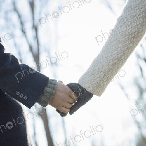 Two people, a couple, a man and woman in the woods on a winter day. Holding hands. Two people, a couple, a man and woman in the woods on a winter day. Holding hands.