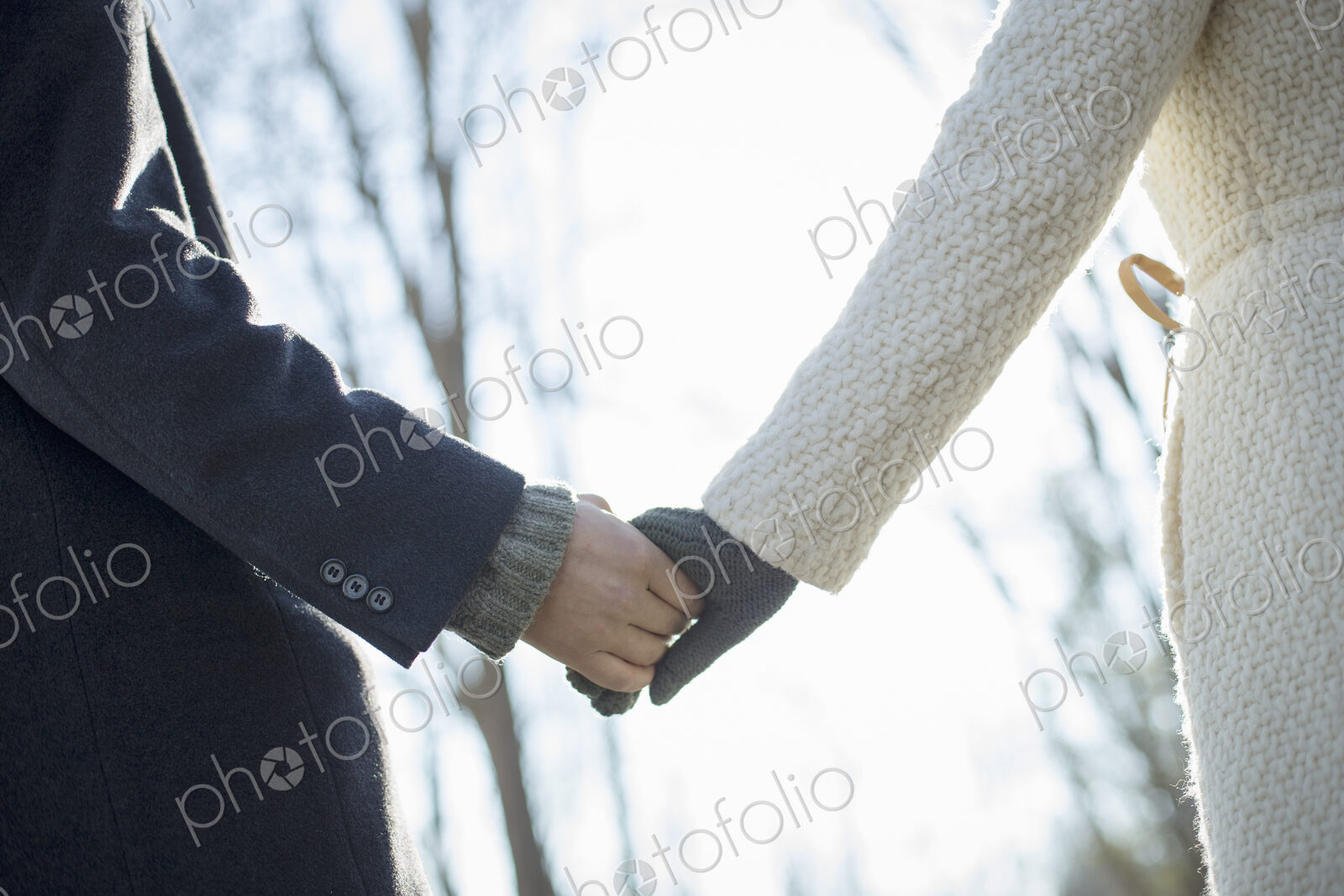 Two people, a couple, a man and woman in the woods on a winter day. Holding hands.