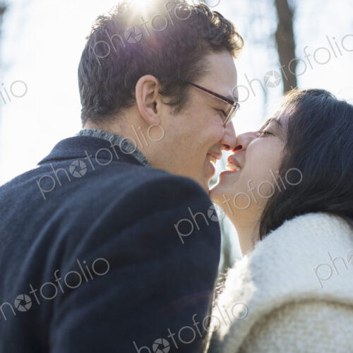 Two people, a couple, a man and woman in the woods on a winter day. Kissing. Two people, a couple, a man and woman in the woods on a winter day. Kissing.