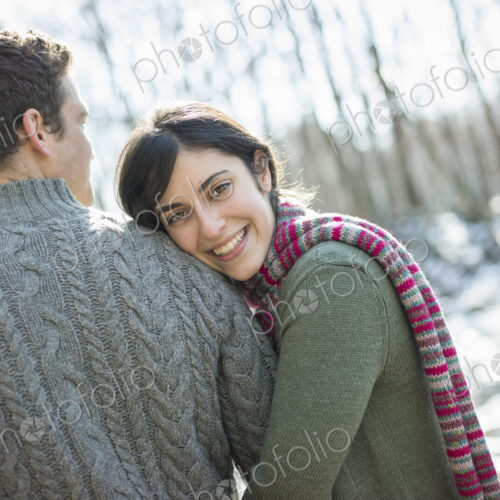 Two people, a couple outdoors on a winter day. Hugging each other. Two people, a couple outdoors on a winter day. Hugging each other.
