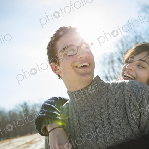 Two people, a man and a woman hugging each other and laughing. A walk on a winter day. Two people, a man and a woman hugging each other and laughing. A walk on a winter day.