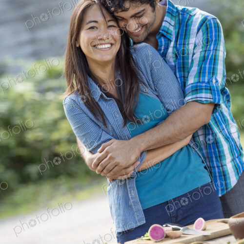 Two people embracing in a garden. Two people embracing in a garden.