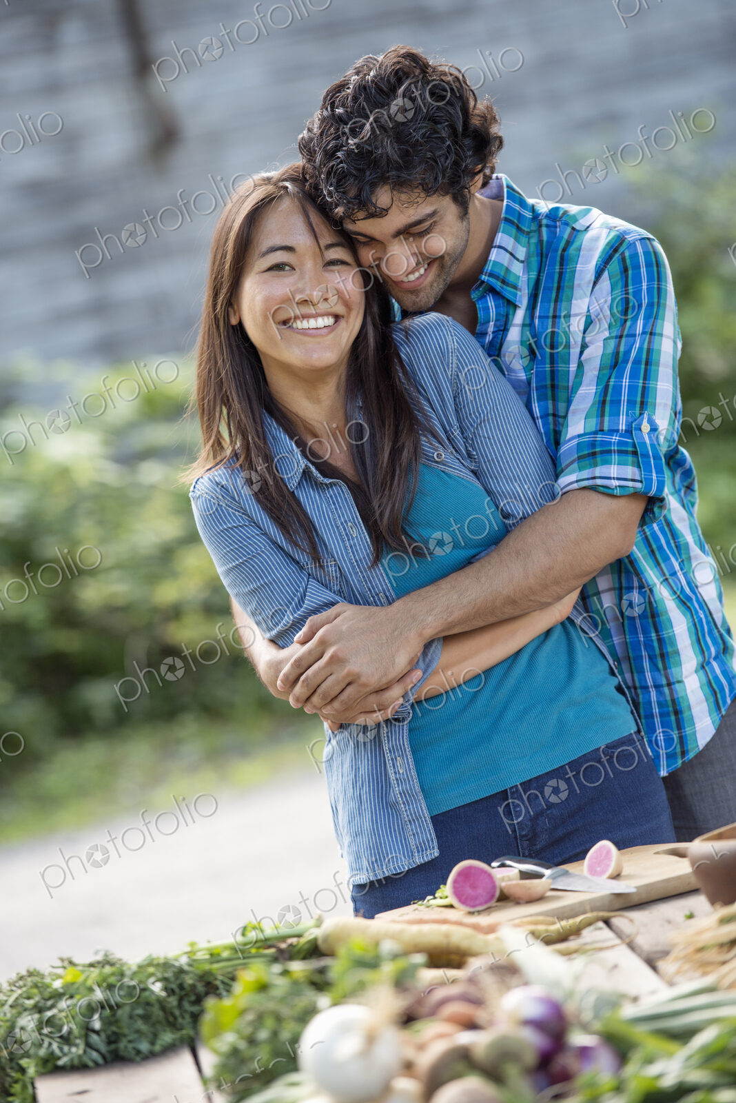 Two people embracing in a garden.
