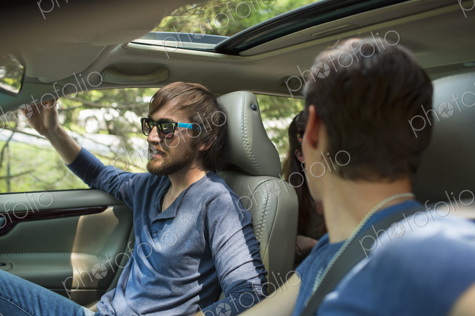 Two people in a car, passenger and driver.