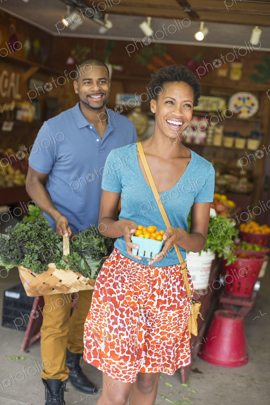 Two people in a farm shop, choosing organic vegetables.