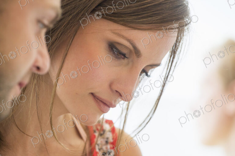 Two people, man and woman looking down.