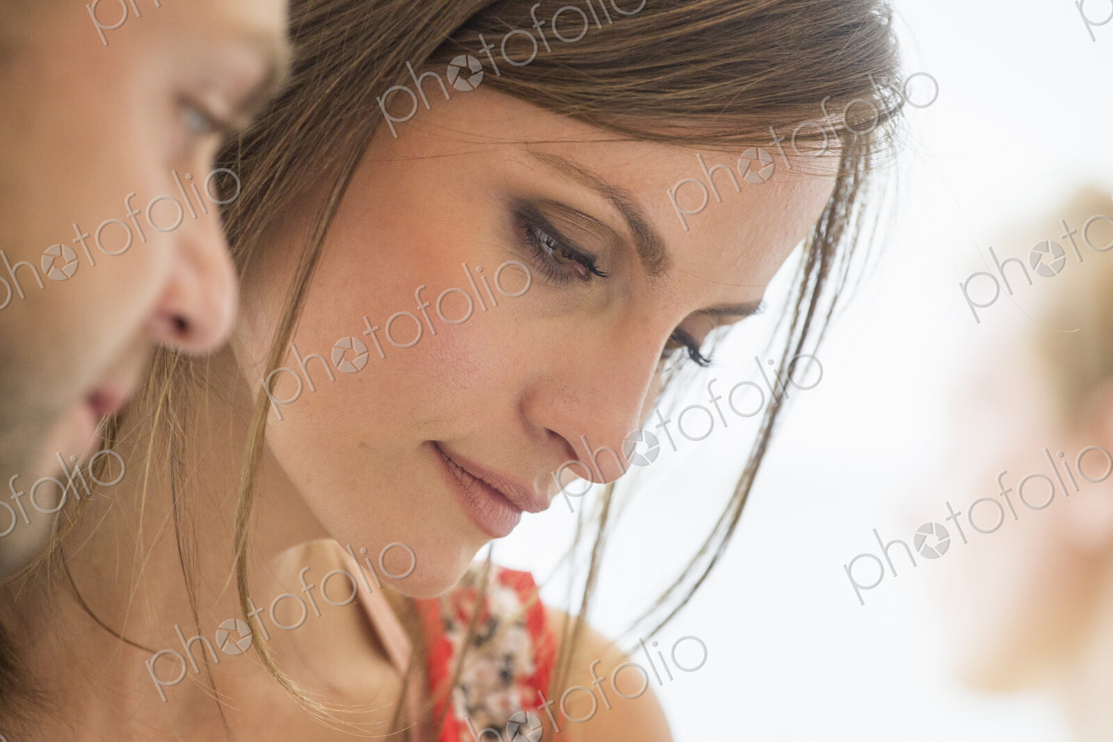 Two people, man and woman looking down.