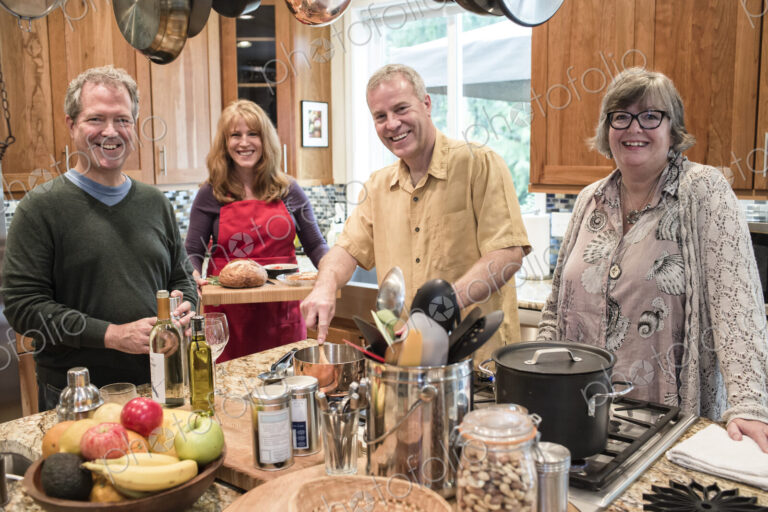 Two senior couples getting together for a dinner party.