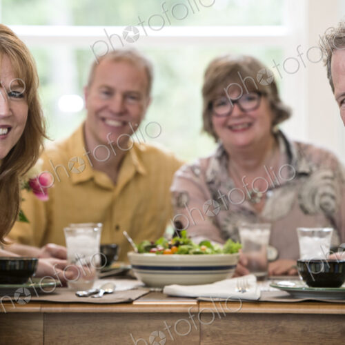 Two senior couples getting together for a dinner party.