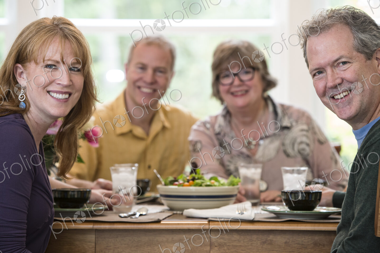 Two senior couples getting together for a dinner party.