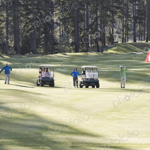 Two senior couples playing golf on a golf course. Two senior couples playing golf on a golf course.