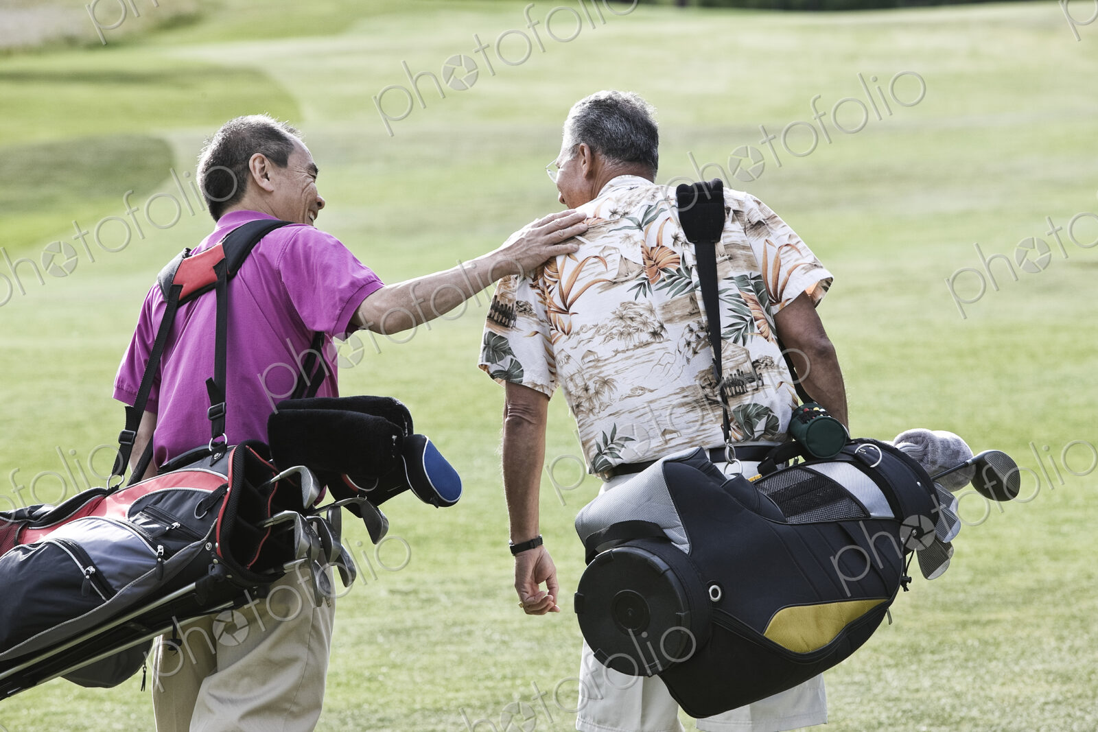 Two senior friends golfing and walking on a fairway toward their next shots.