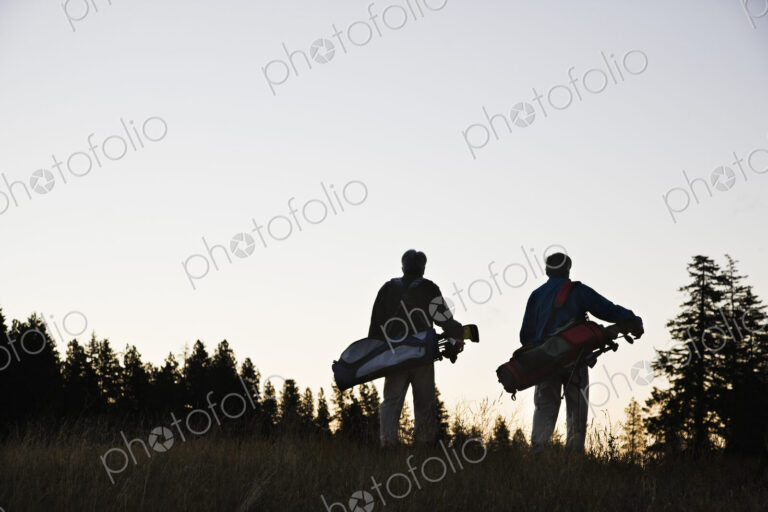 Two seniors walking down the fairway toward the next golf green.