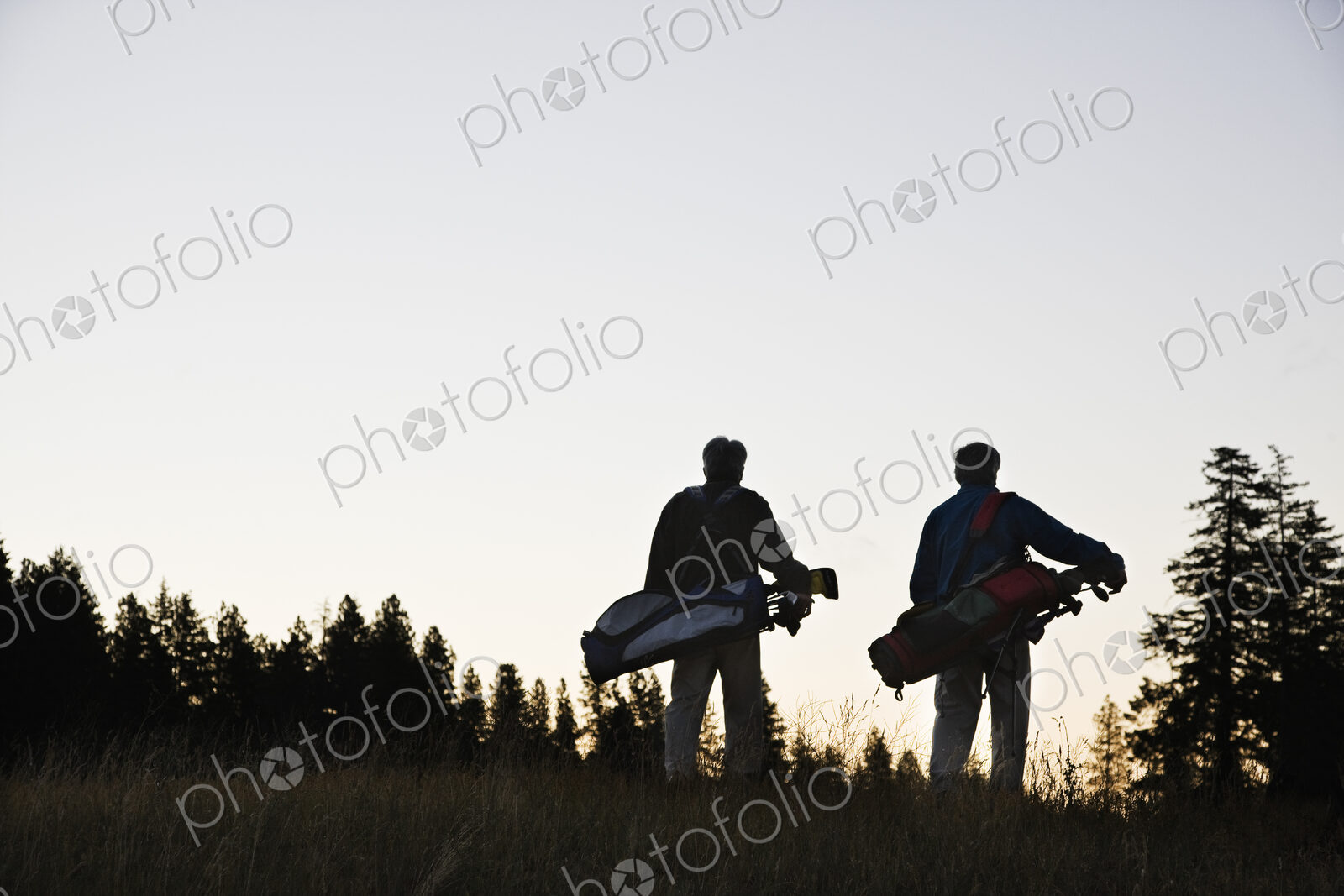 Two seniors walking down the fairway toward the next golf green.