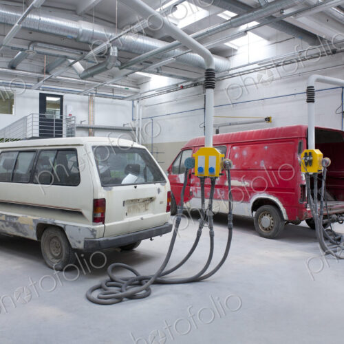 Two vans in a large repair workshop for repair and respraying