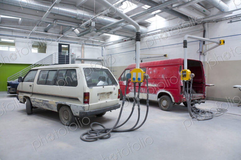 Two vans in a large repair workshop for repair and respraying