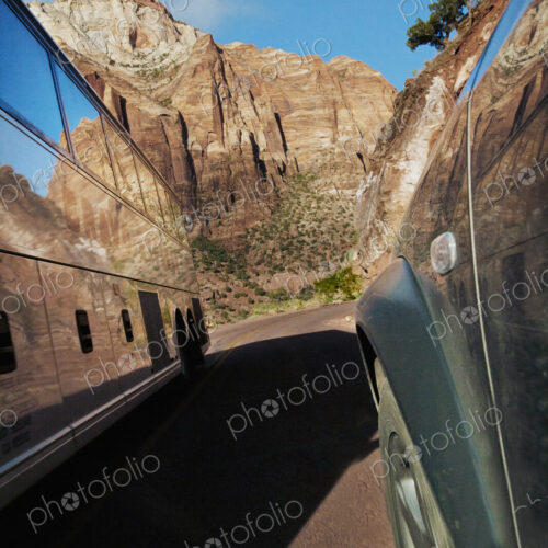 Two vehicle on the road, a public transportation tour bus going through Zion National… Two vehicle on the road, a public transportation tour bus going through Zion National…