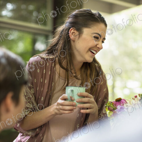 Two woman at a table talking and laughing. Two woman at a table talking and laughing.