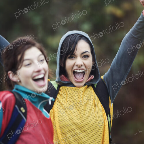 Two women cheering at an informal outdoor sporting event. Two women cheering at an informal outdoor sporting event.