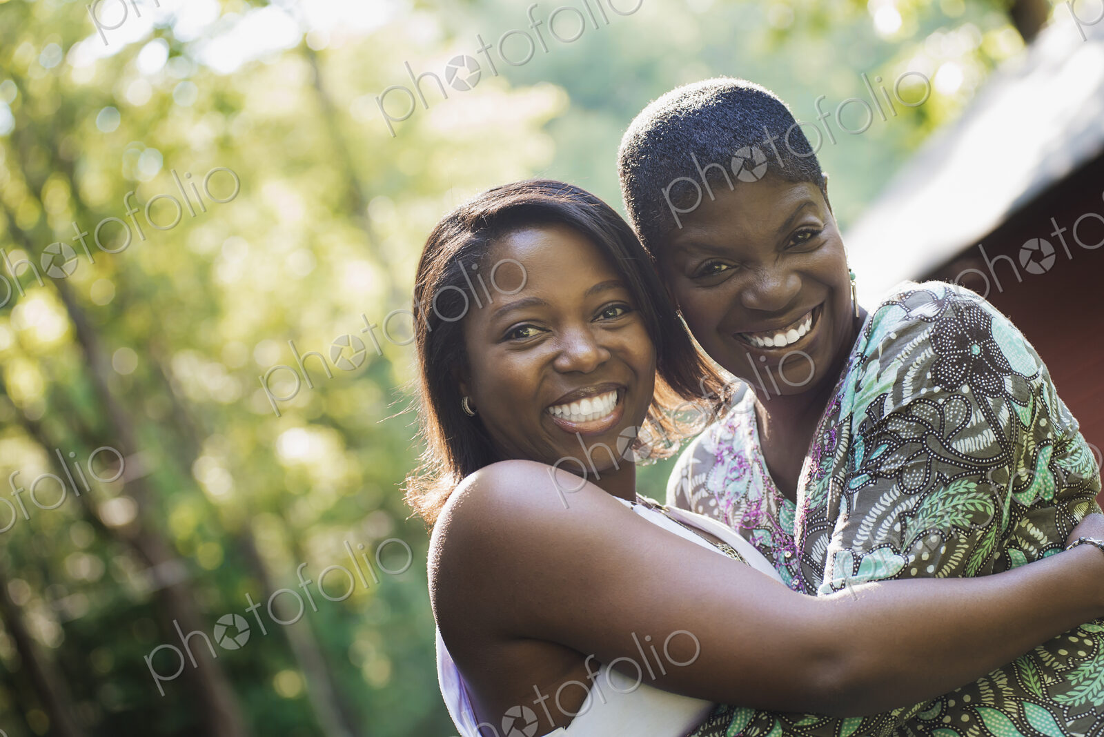 Two women embracing each other and laughing.