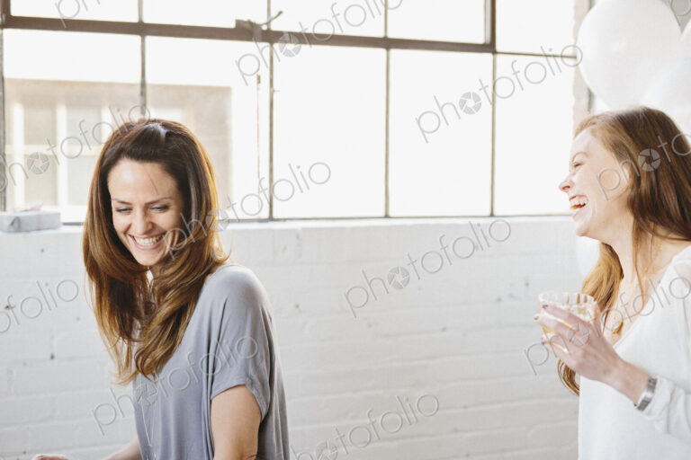 Two women laughing together