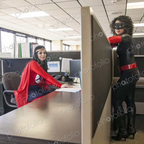 Two women office super hero's in their office. Two women office super hero's in their office.
