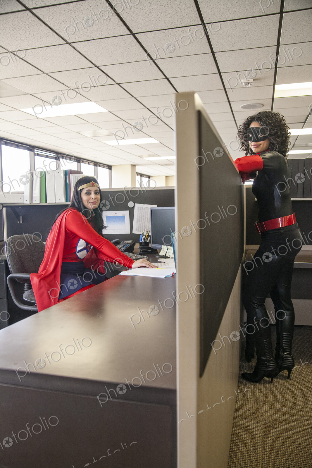 Two women office super hero’s in their office.