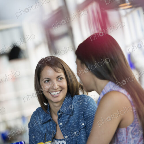 Two women seated at a cafe table having a meal.