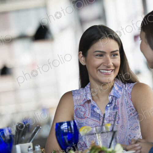 Two women seated at a cafe table having a meal.