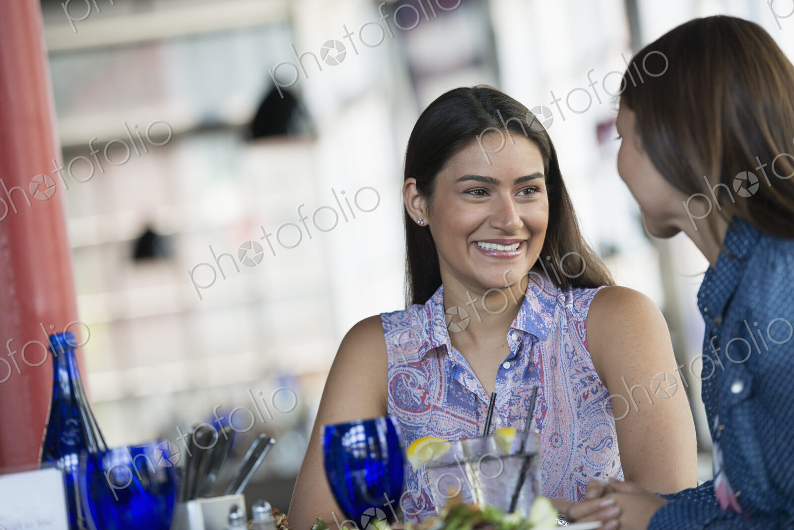 Two women seated at a cafe table having a meal.