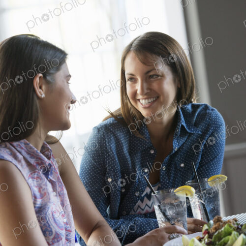Two women seated at a cafe table having a meal.
