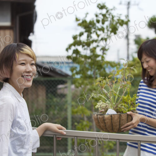 Two women standing in a garden.