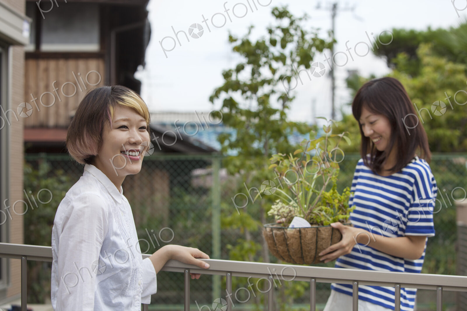 Two women standing in a garden.