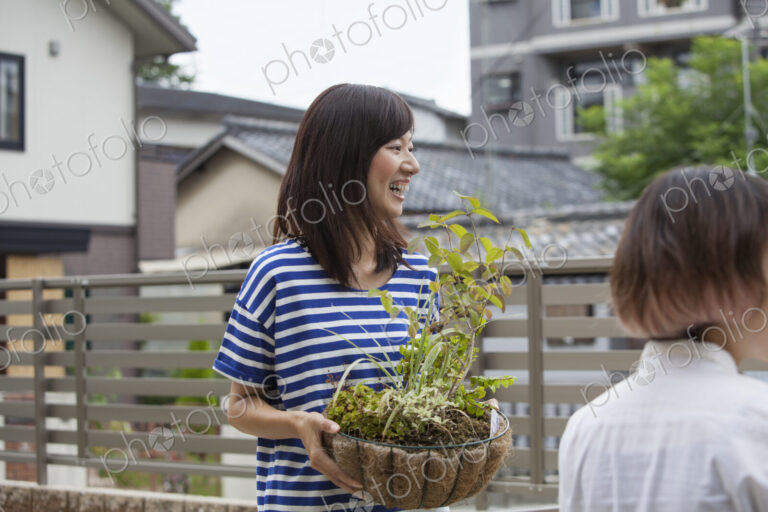 Two women standing in a garden.