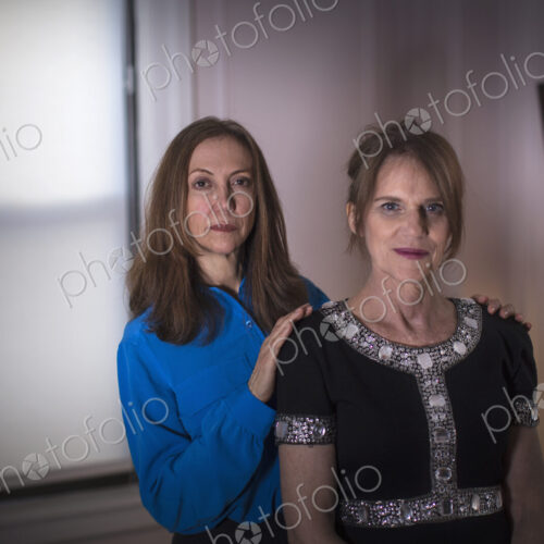 Two women standing, one behind the other. Two women standing, one behind the other.
