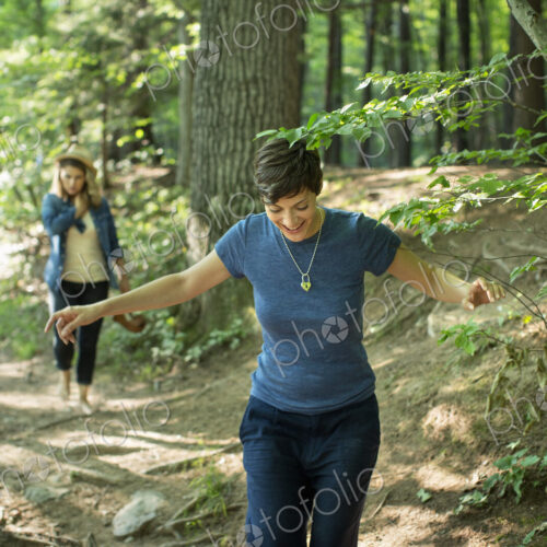 Two women walking down a woodland path. Two women walking down a woodland path.