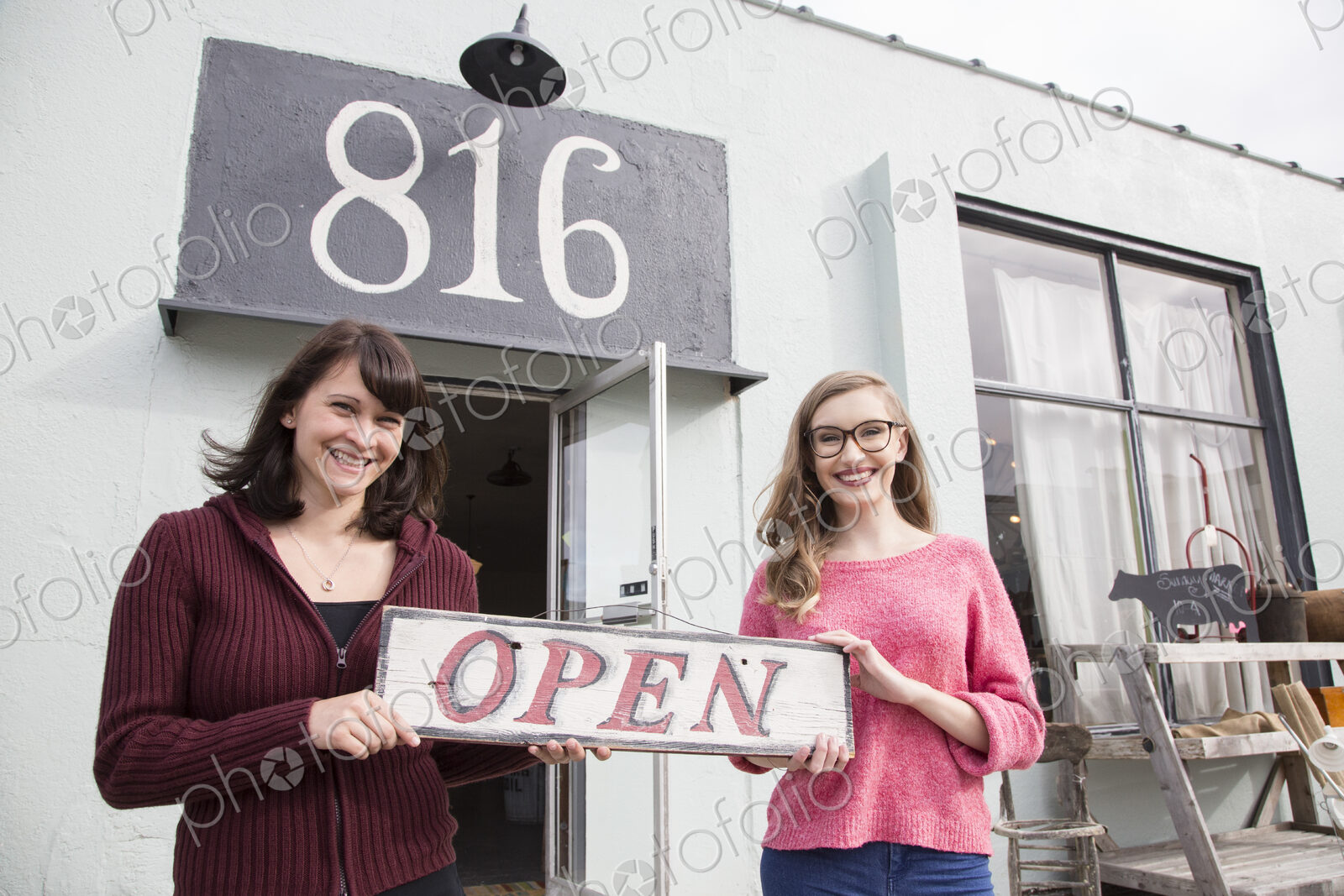 Two young caucasian women owners of a new antique store.