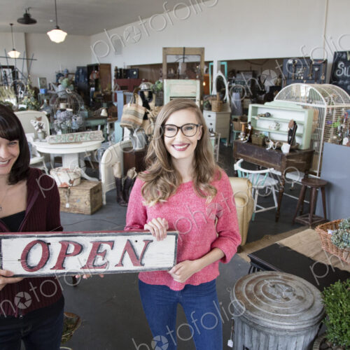 Two young caucasian women owners of a new antique store. Two young caucasian women owners of a new antique store.