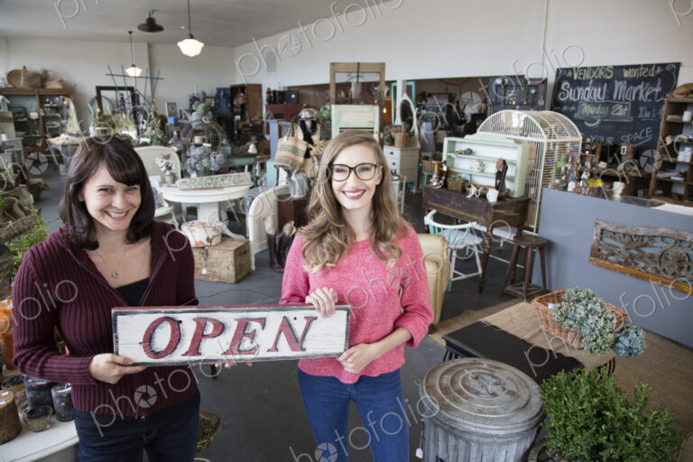 Two young caucasian women owners of a new antique store.