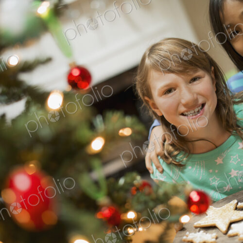 Two young girls with a tray of organic baked and iced Christmas cookies. Two young girls with a tray of organic baked and iced Christmas cookies.