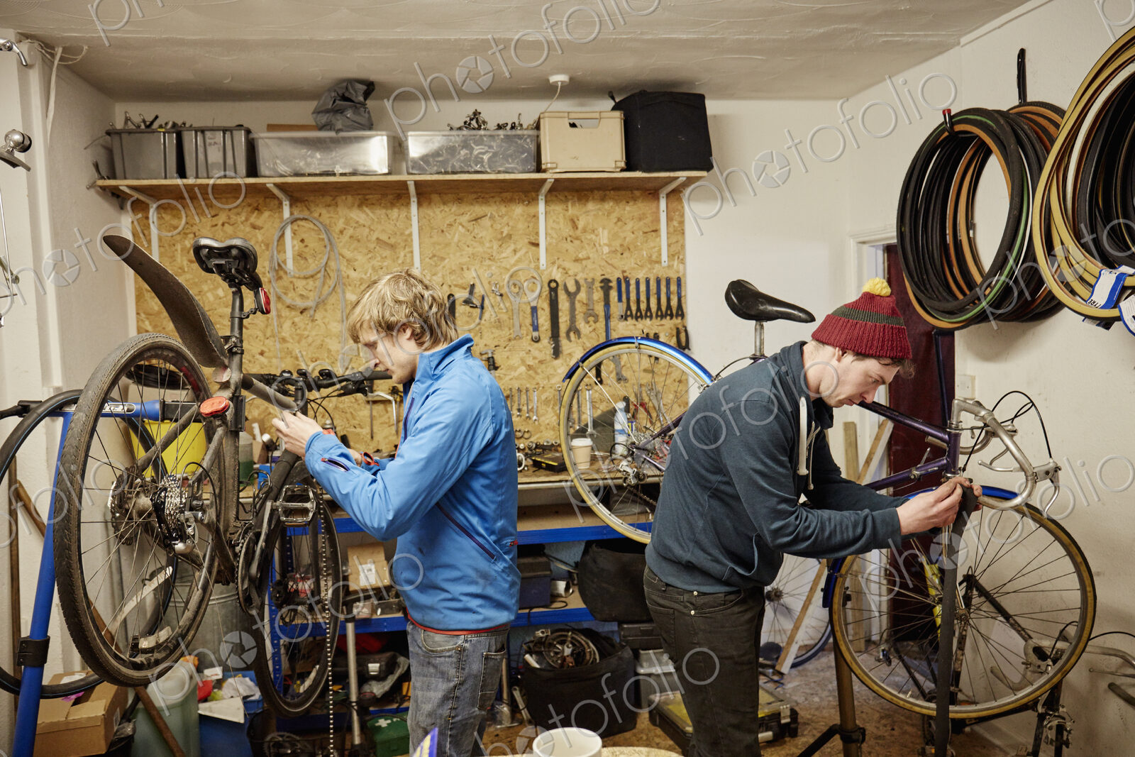 Two young men in a cycle shop, talking.
