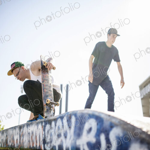 Two young people skateboarding, at a skate park. Two young people skateboarding, at a skate park.