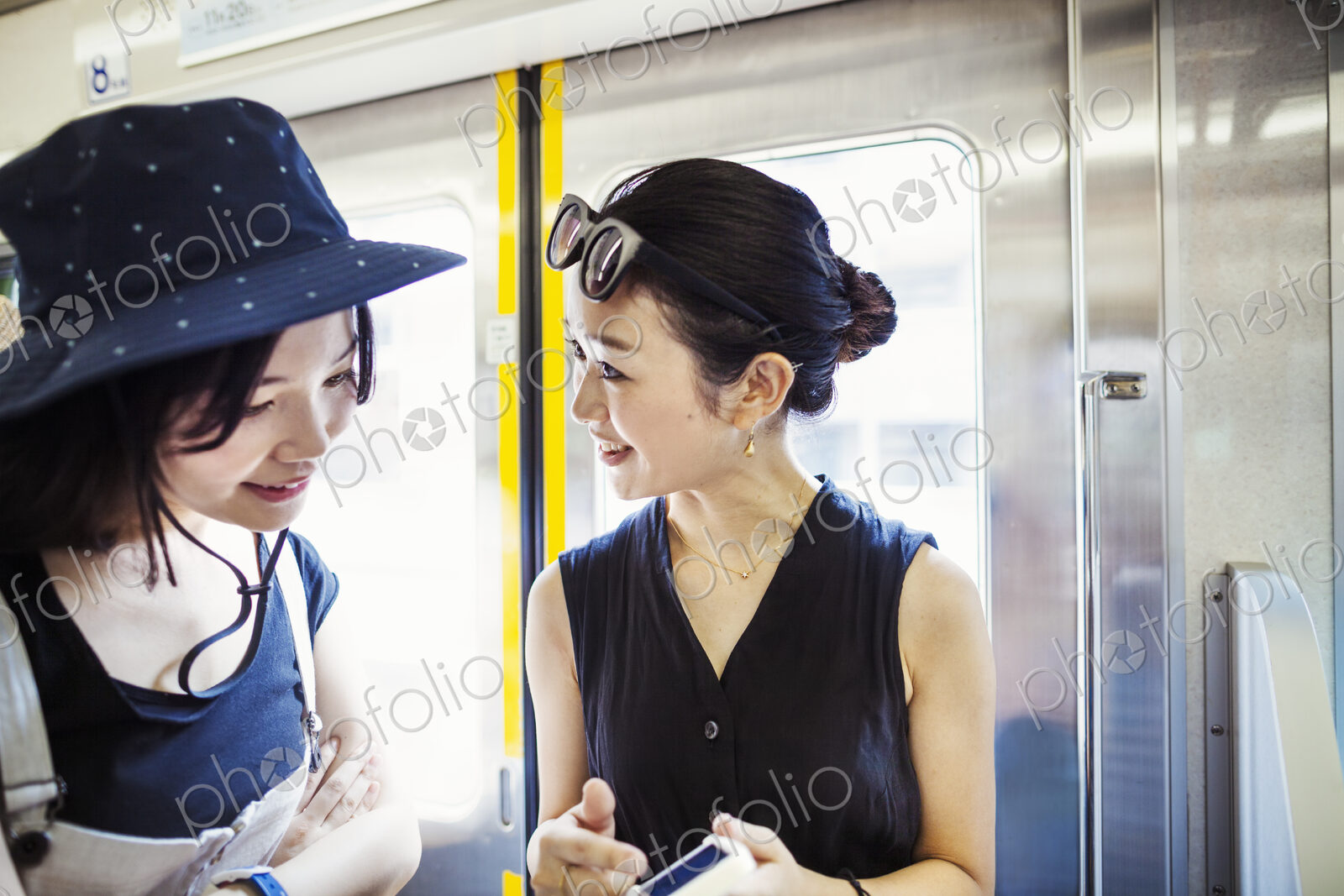 Two young woman traveling on a train.