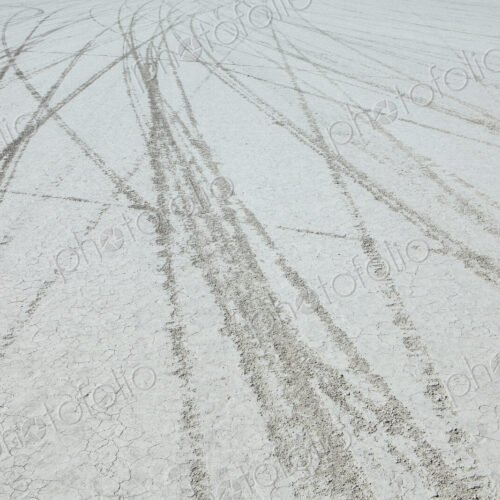 Tyre marks and tracks in the playa salt pan surface of Black Rock Desert, Nevada.