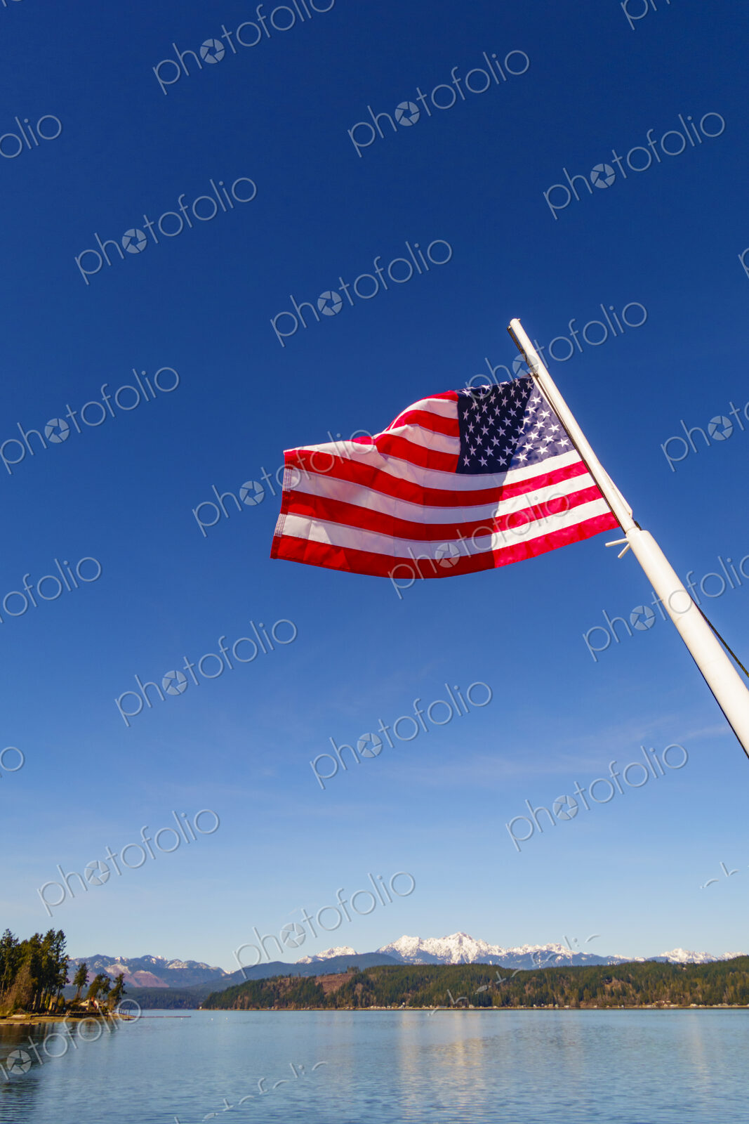 US Flag on flag pole, Hood Canal, WA USA