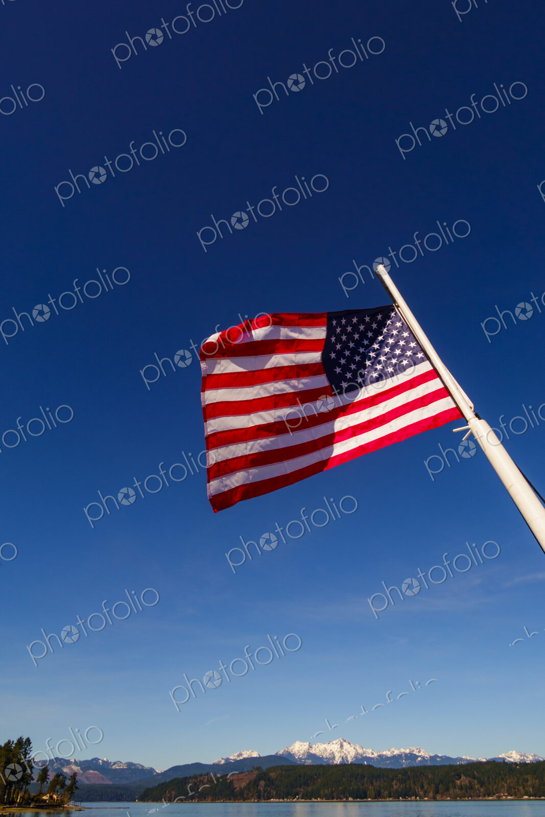 US Flag on flag pole, Hood Canal, WA USA